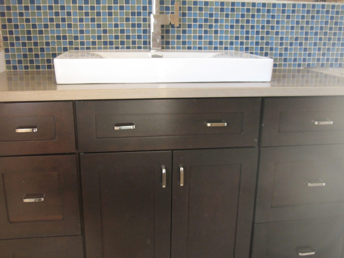 A bathroom with a sink and cabinets in it