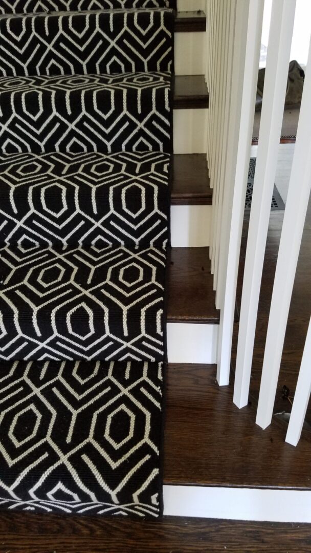 A black and white carpet on the stairs