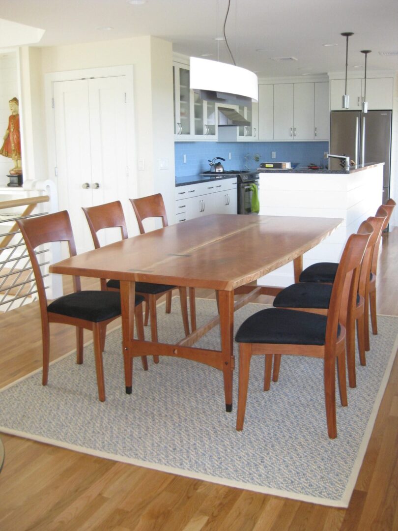 A dining room table with chairs around it