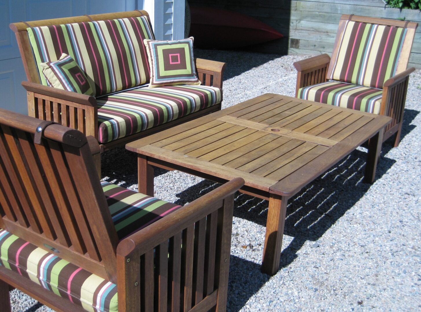 A patio set with striped cushions and table.