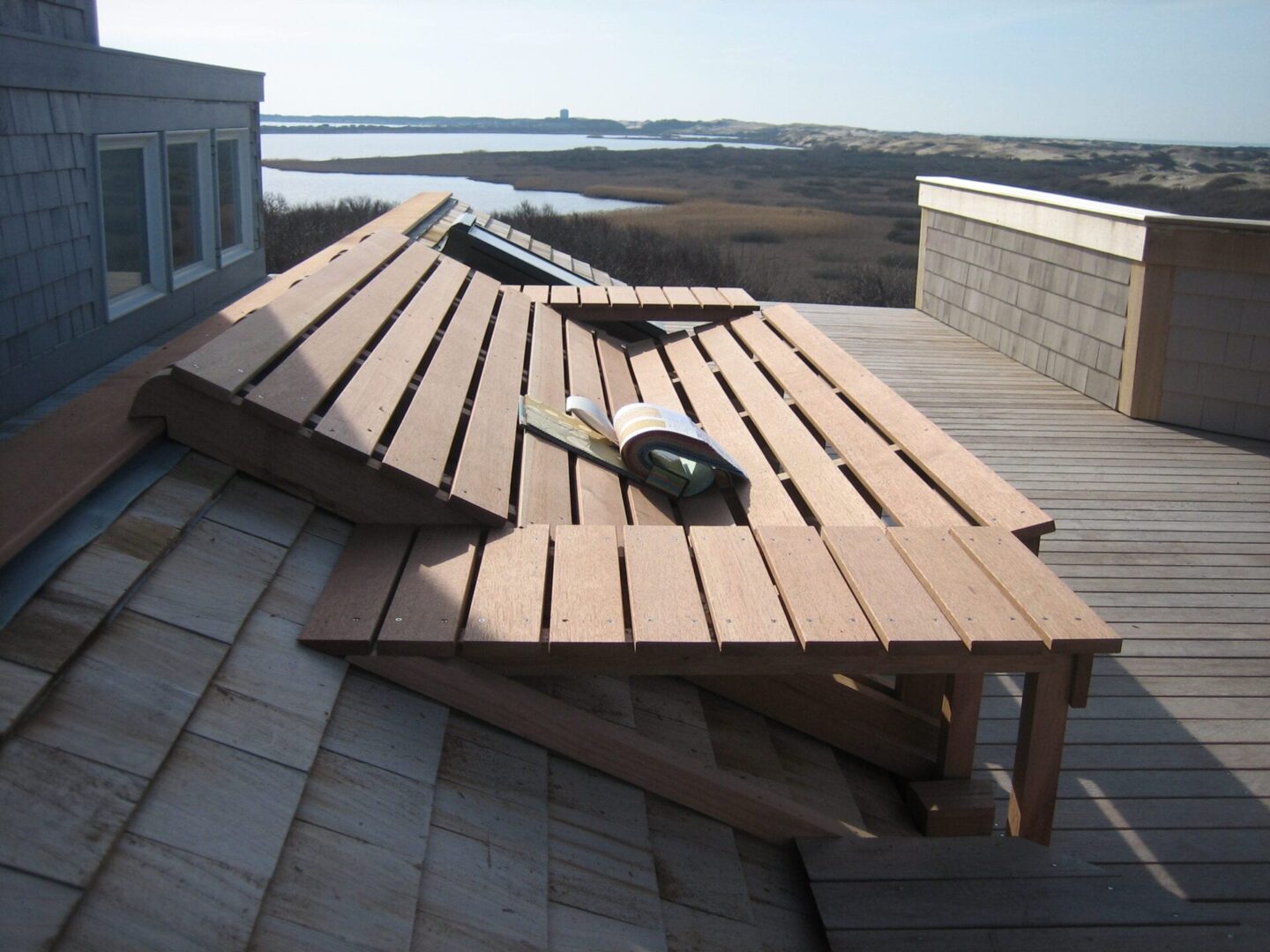 A wooden bench on top of a roof.